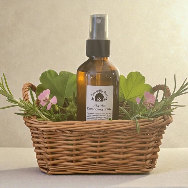 Silky hair detangling spray with rosemary and geranium leaves set in a basket